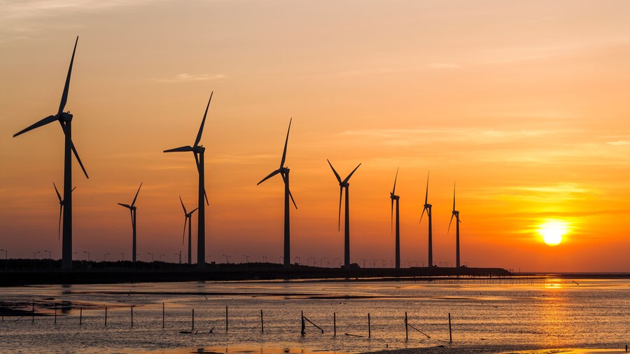 sunset view of Gaomei wetlands landscape and the wind power plant in Taichung, Taiwan. energy systems and renewable energy.
