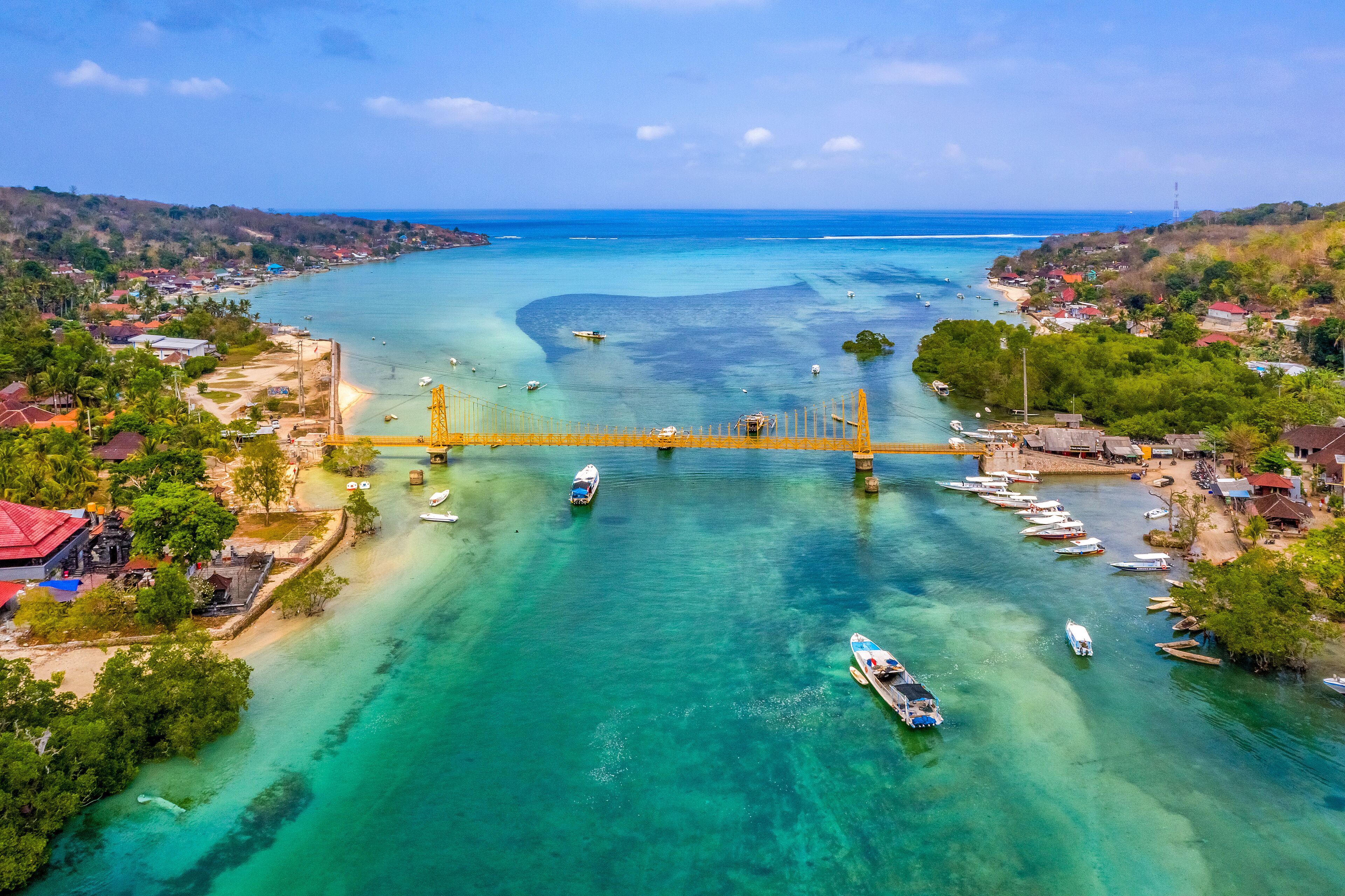 Aerial view of Yellow bridge between the islands of Nusa Ceningan and Nusa Lembongan, Bali in Indonesia