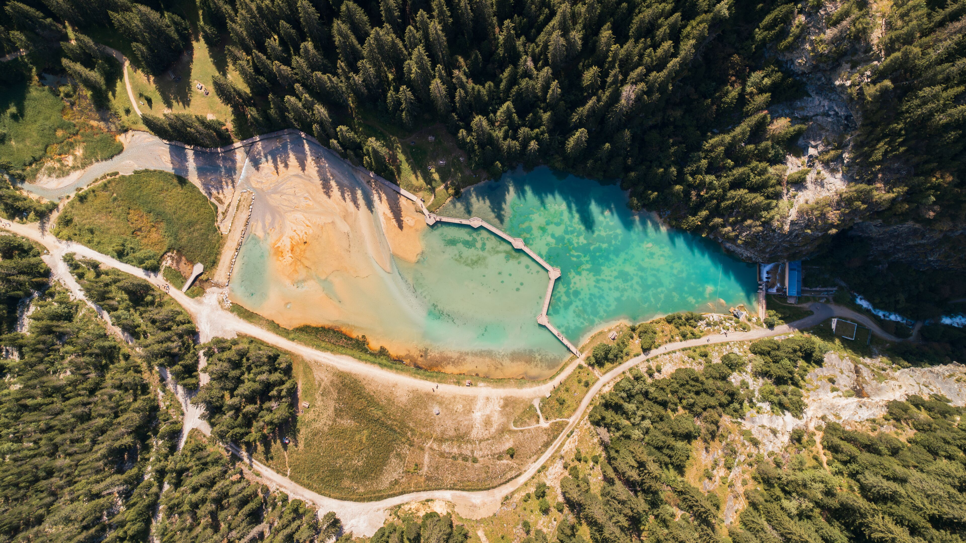 Aerial photo by drone of the Rosière lake and the forest in Courchevel in the Tarentaise valley in France