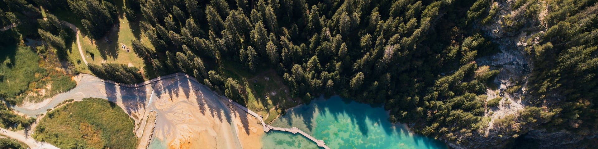 Aerial photo by drone of the Rosière lake and the forest in Courchevel in the Tarentaise valley in France