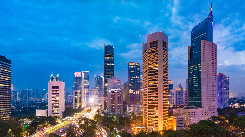 Aerial view of Jakarta's Central Business District at dusk (blue hour). Jakarta cityscape at sunset. A panorama stitched from 3 photos. Jakarta cityscape. Widescreen photo.