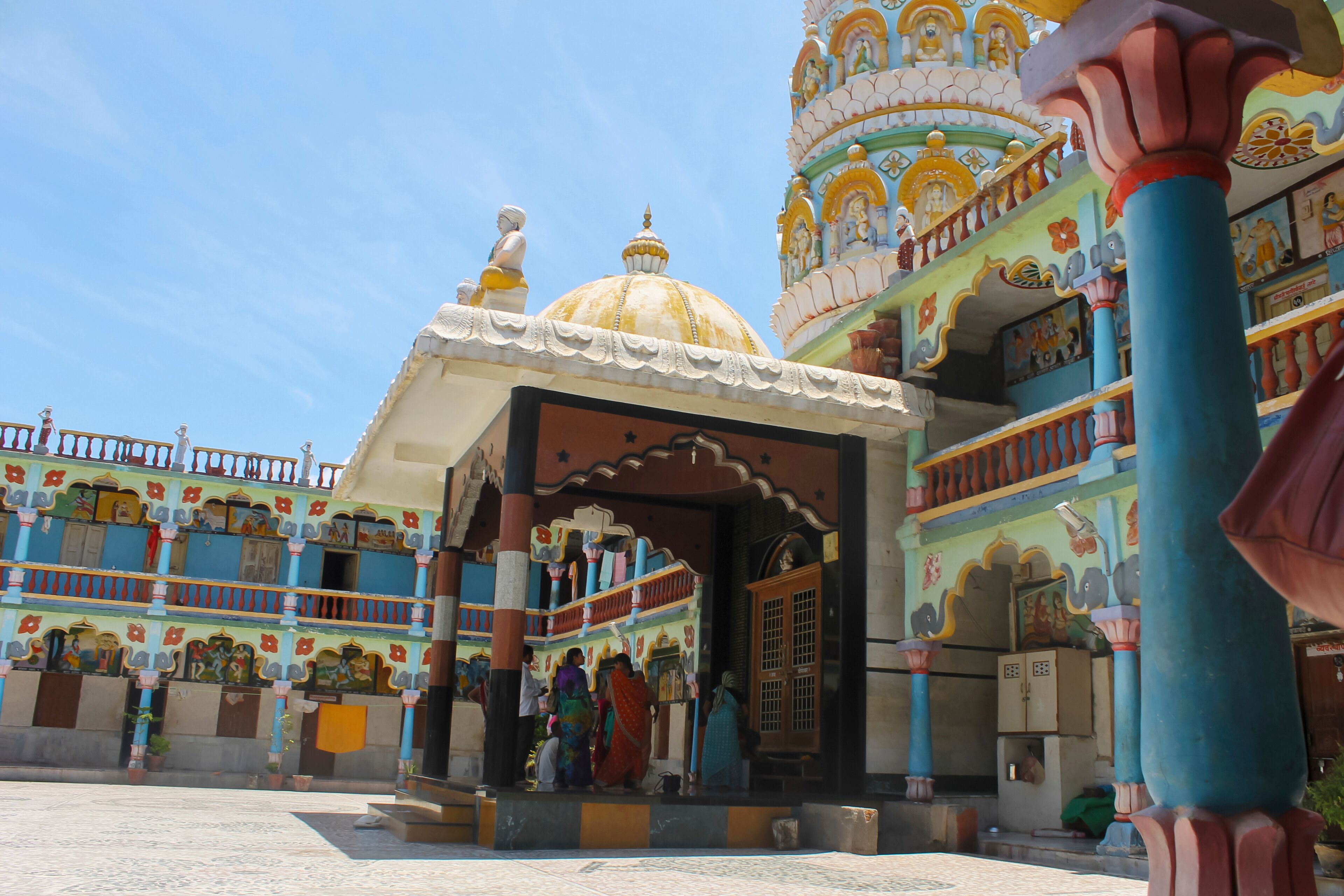 A colorful temple with intricate architecture and a large dome.