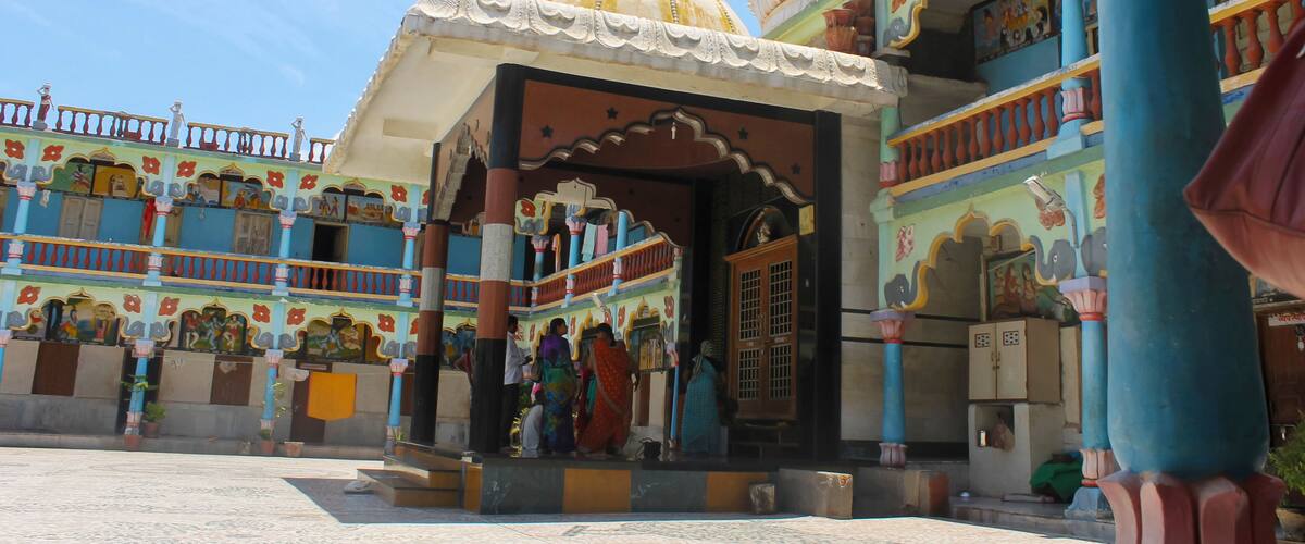 A colorful temple with intricate architecture and a large dome.