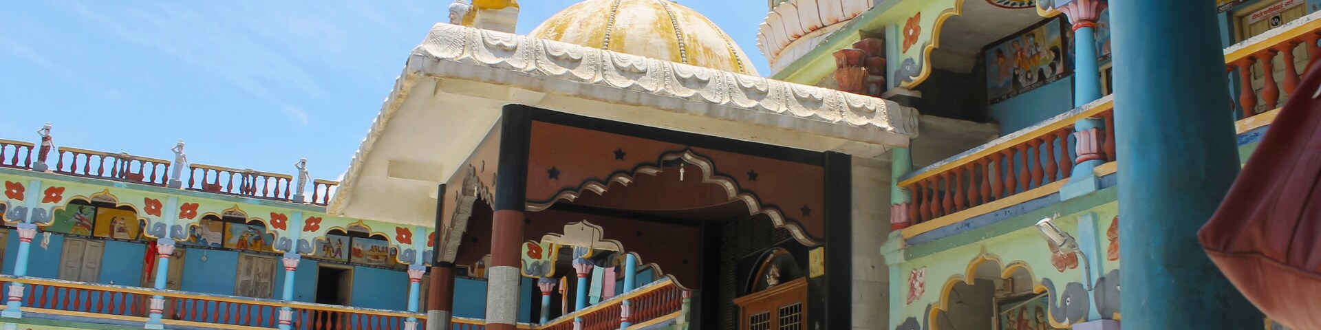 A colorful temple with intricate architecture and a large dome.