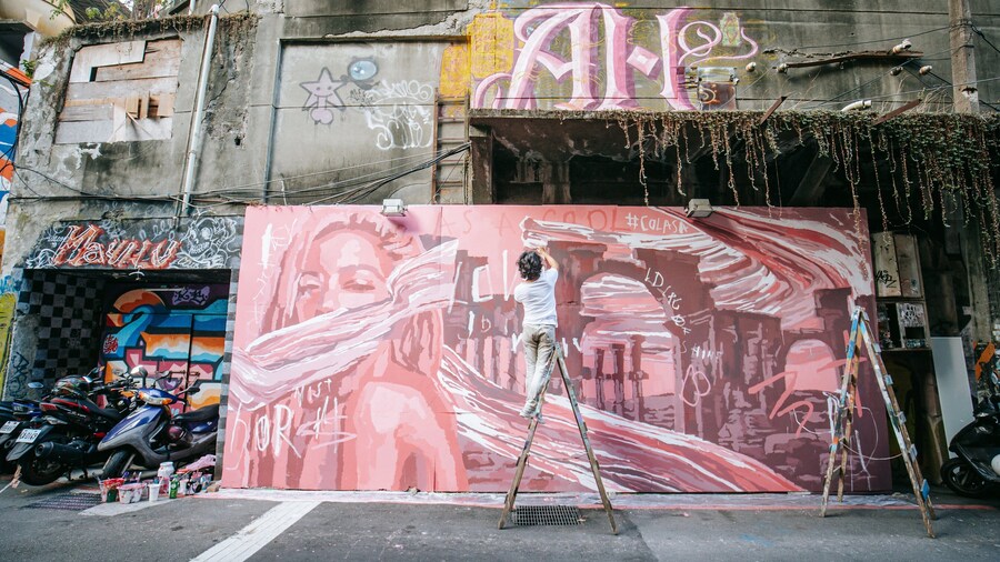 Taipei Cinema Park featuring outdoor art as well as an individual male