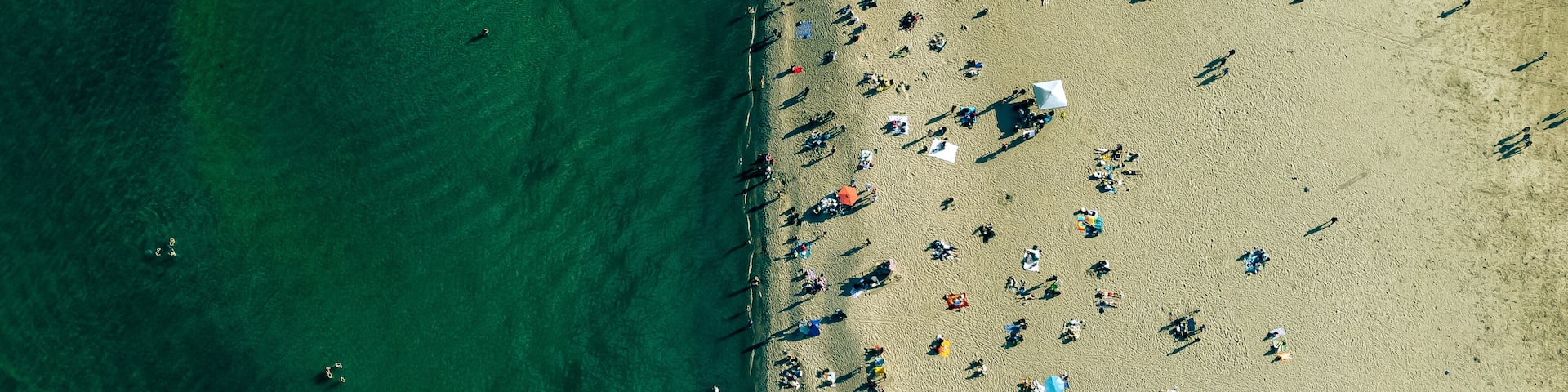 Toronto woodbine beach drone shot with a top view of the beach. The people enjoying summer on the beach.