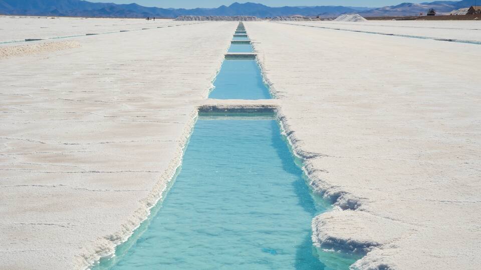 A salt flat with a long, narrow water channel.