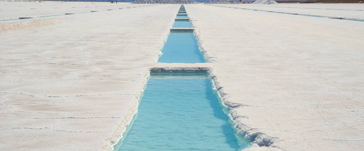A salt flat with a long, narrow water channel.