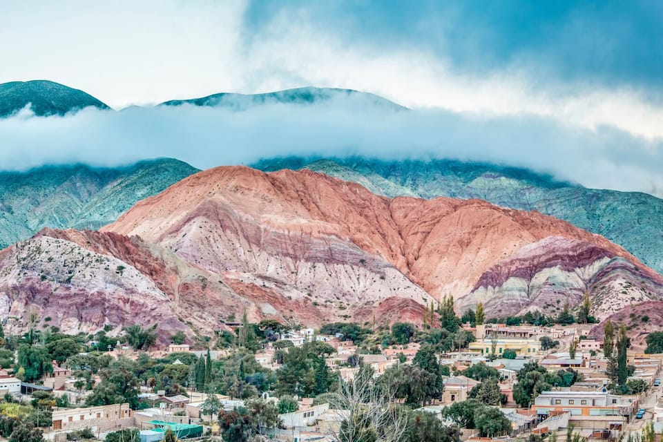 A town nestled between mountains with a road leading towards the town.