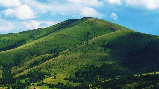 Green Zlatibor mountain hill landscape with beautiful clouds in background
