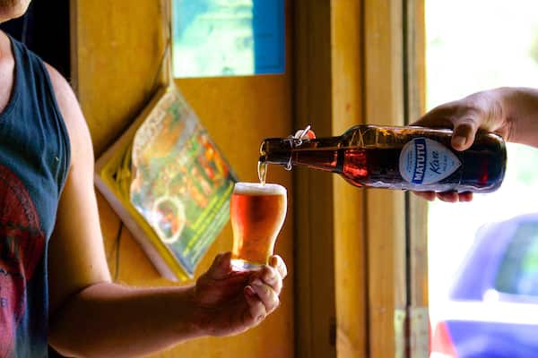 A person pouring beer into a glass.