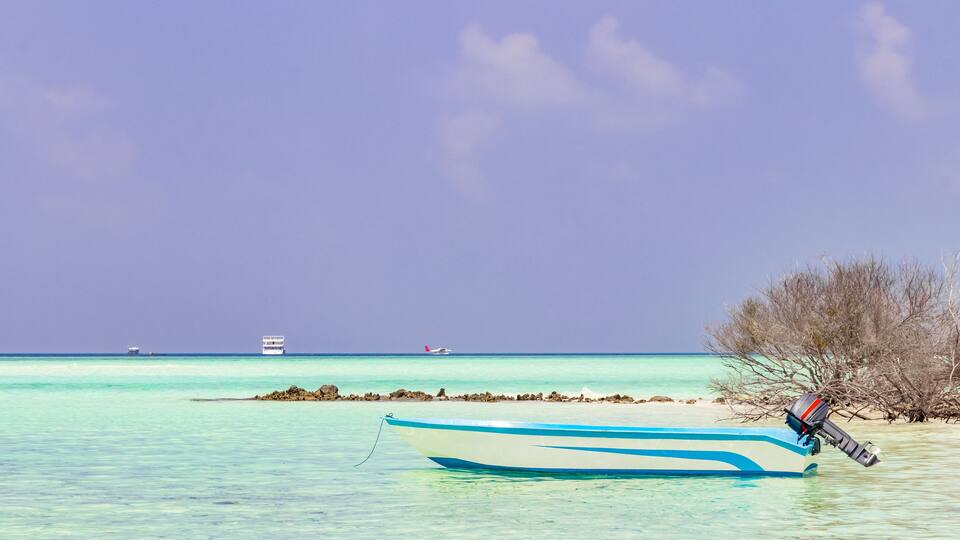 Boats boat trip Rasdhoo island Maldives in beautiful clear water.