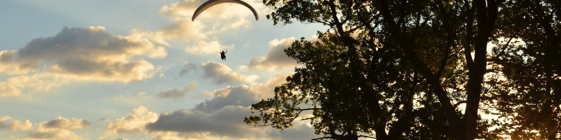 Morning view of Cleveland skyline, lake Erie, and paraglider from Edgewater park