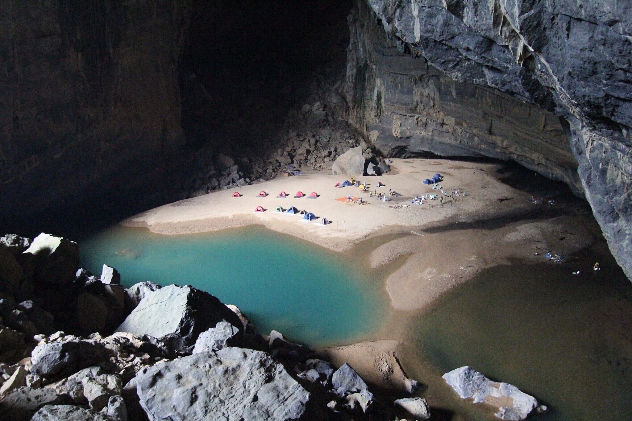 This is the 3rd largest cave and is the entrance to Son Doong the world's largest cave. The contrast of the bright blue water is striking against the cave walls. #instone