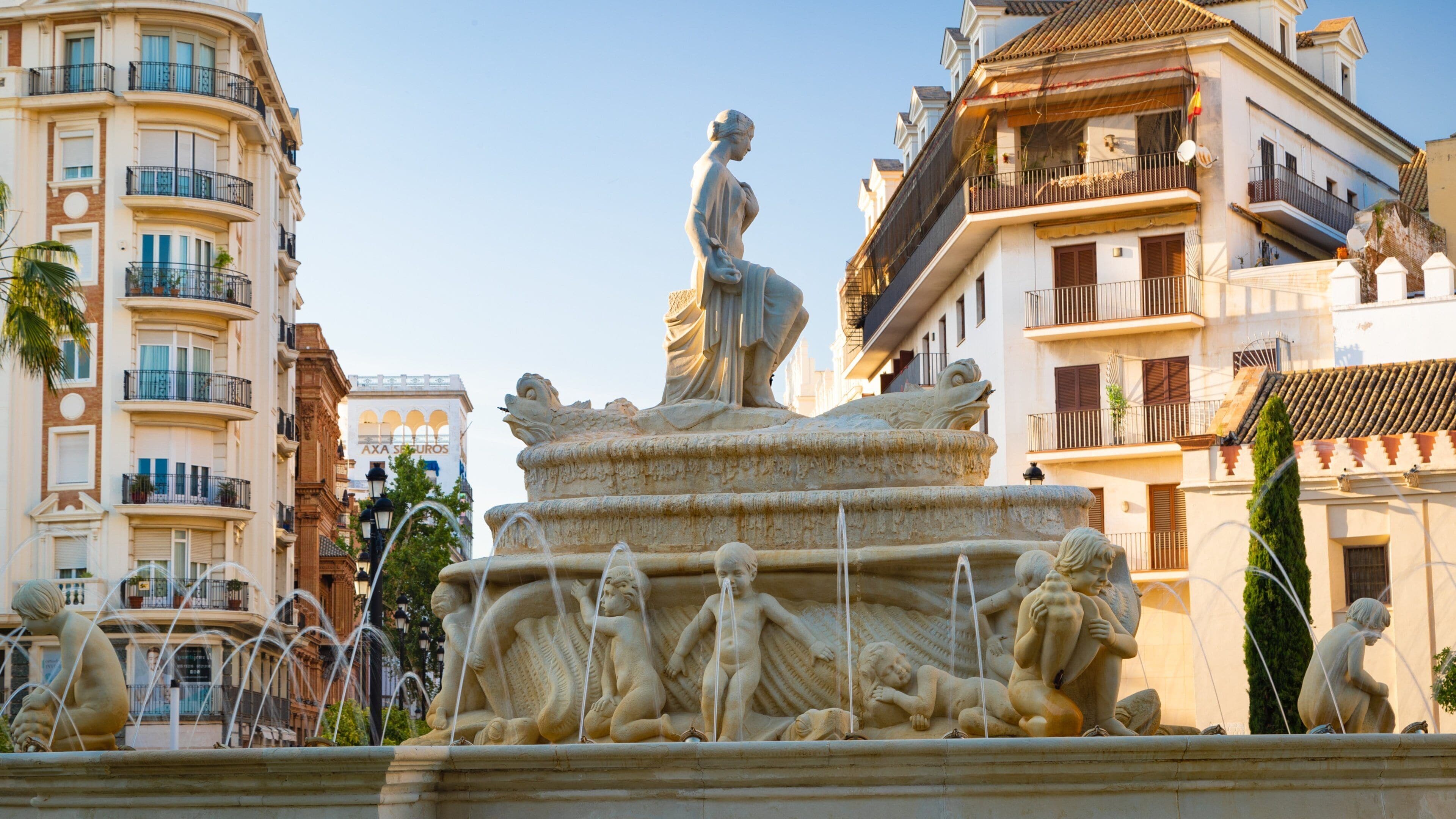 Plaza de Puerta Jerez featuring a fountain and a city