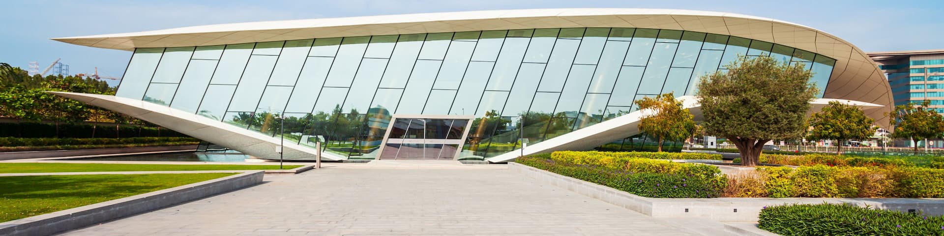 A modern building with a curved roof and large glass windows.