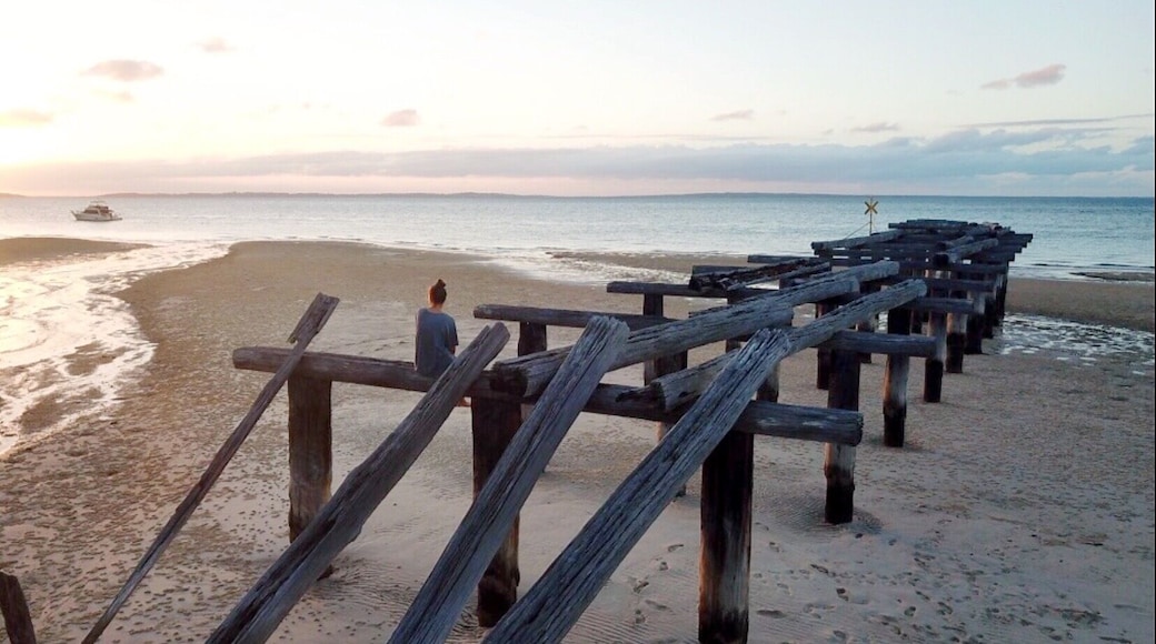 My daughter on McKenzie Pier, Fraser Island QLD AU at sunset