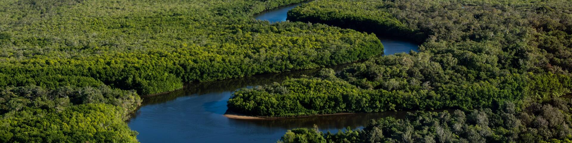 Aerial photo on a flight over Cape York from Cooktown to the tip of Australia. Crocodile country with very winding river and green bushland. Queensland, Australia