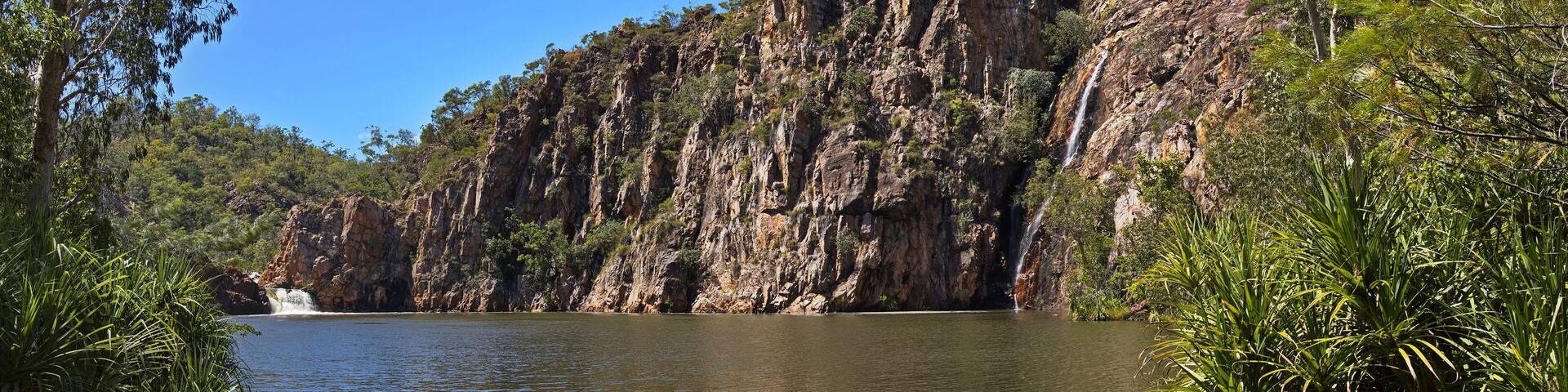 A river flowing through a rocky gorge with cliffs and waterfalls.