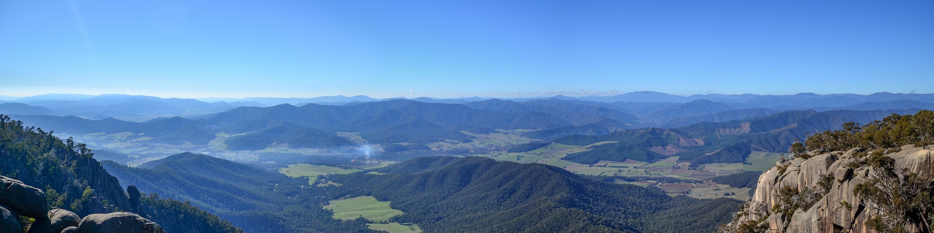 Panoramic mountain landscape with rolling peaks from Mount Buffalo in Australia. The Australian Alps and green valley in Victoria's high country.