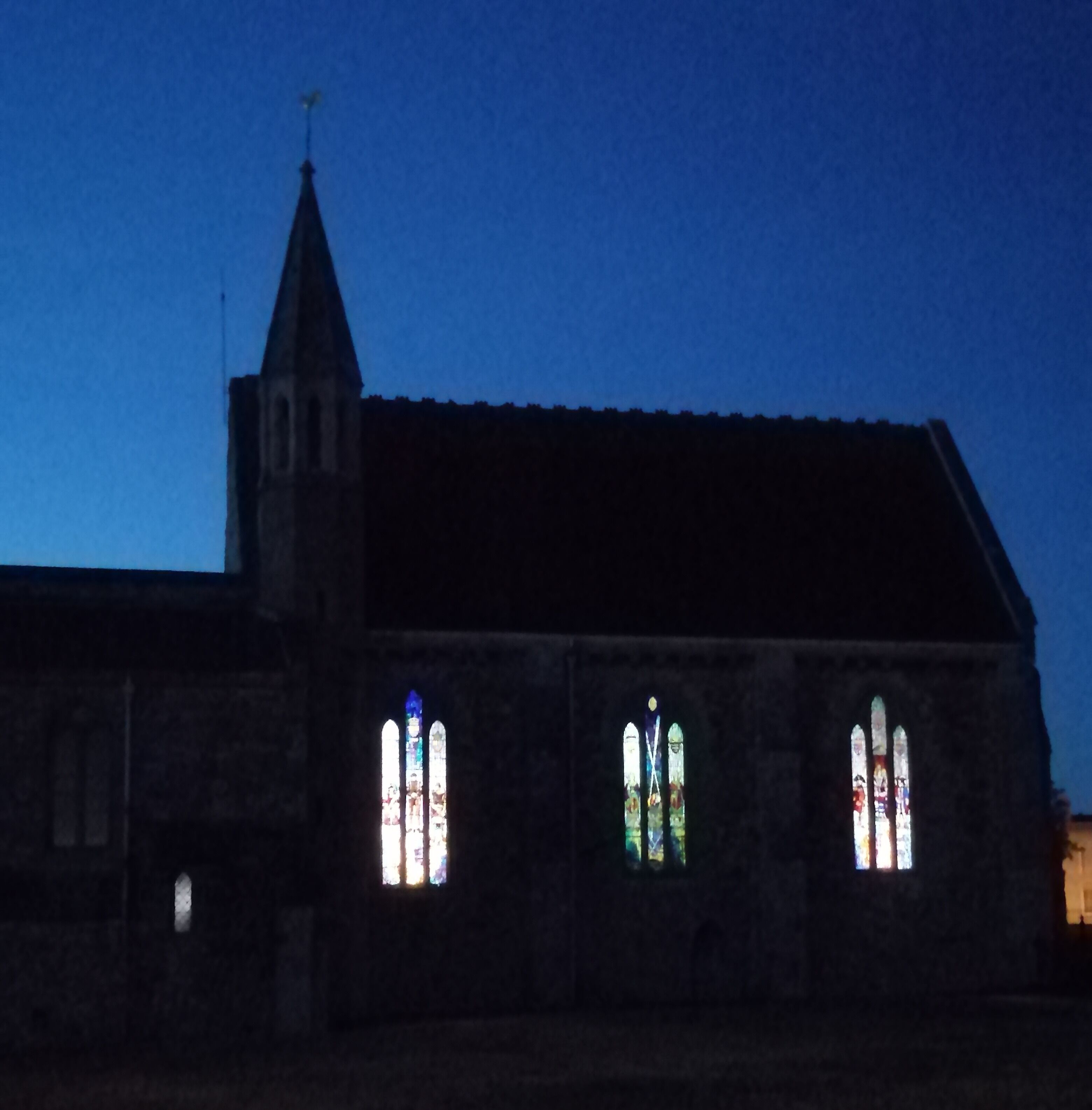 At sunset with lights behind beautiful stained glass windows