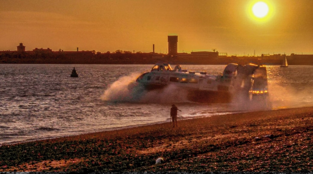 Regular hovercraft passenger service from Portsmouth to Ryde on the Isle of Wight. Sun setting over the former Haslar Royal Navy hospital in Gosport.