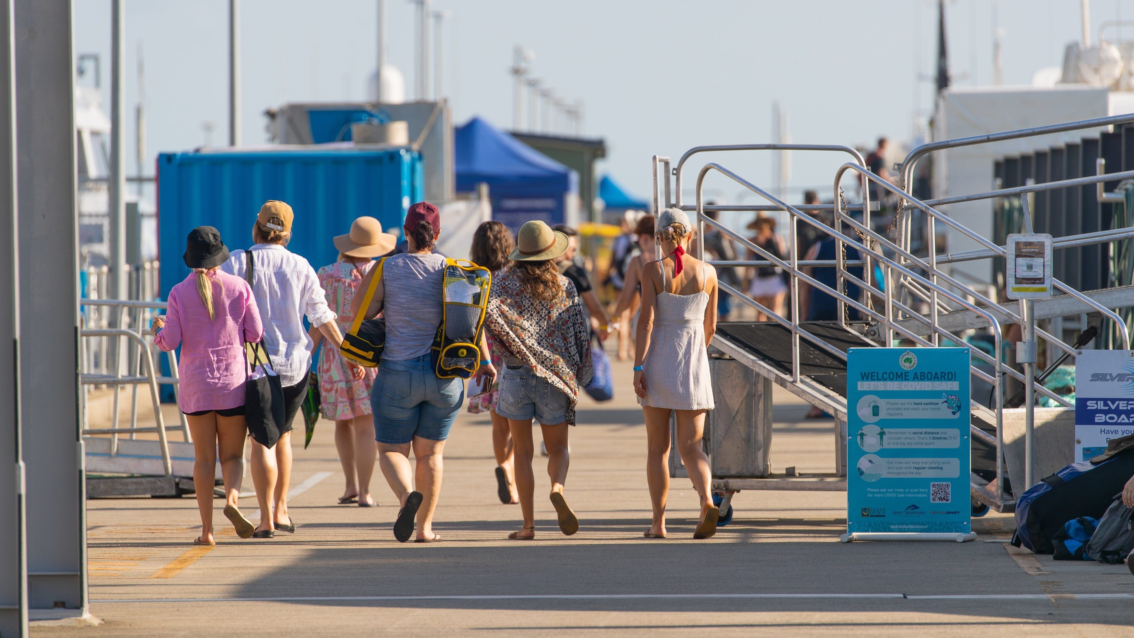 Cairns Marlin Marina which includes a bay or harbor and street scenes as well as a small group of people