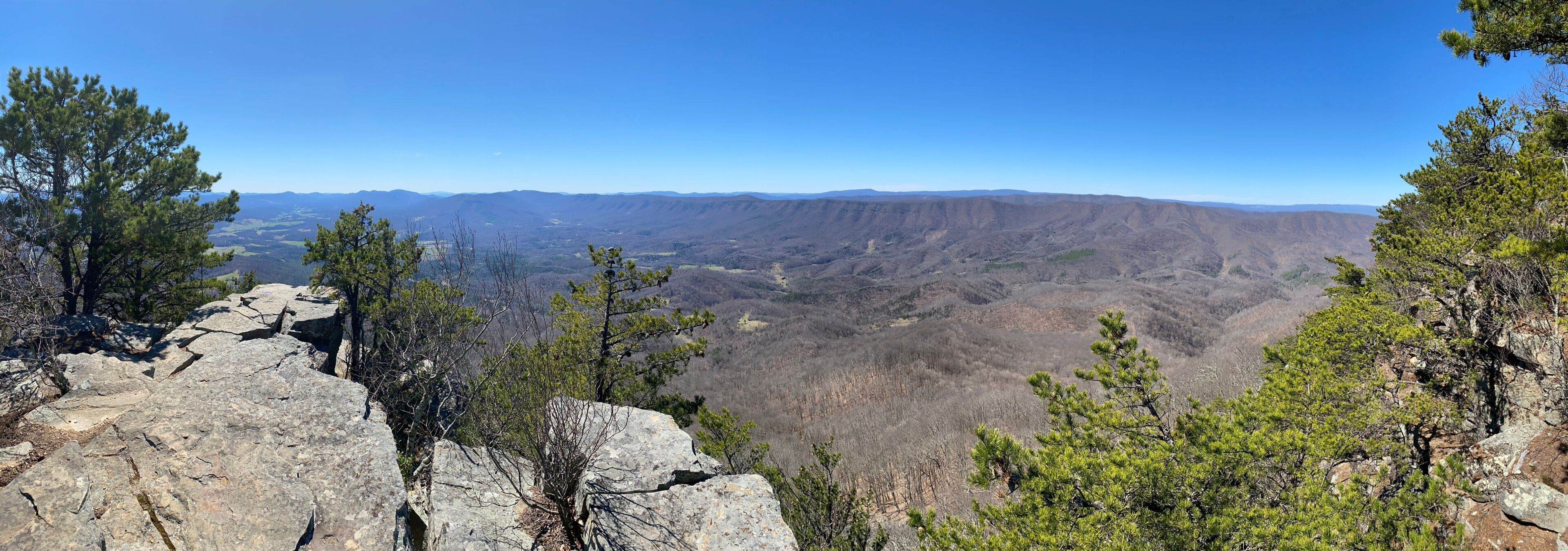 A mountainous landscape with rocky outcrops and scattered trees.