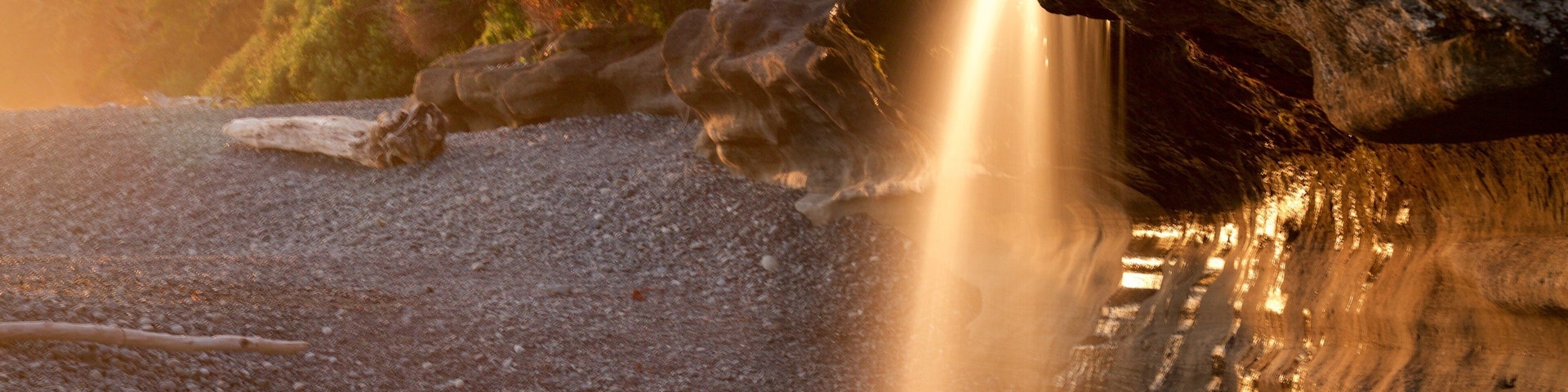 Sandcut Beach which includes a sunset and a pebble beach