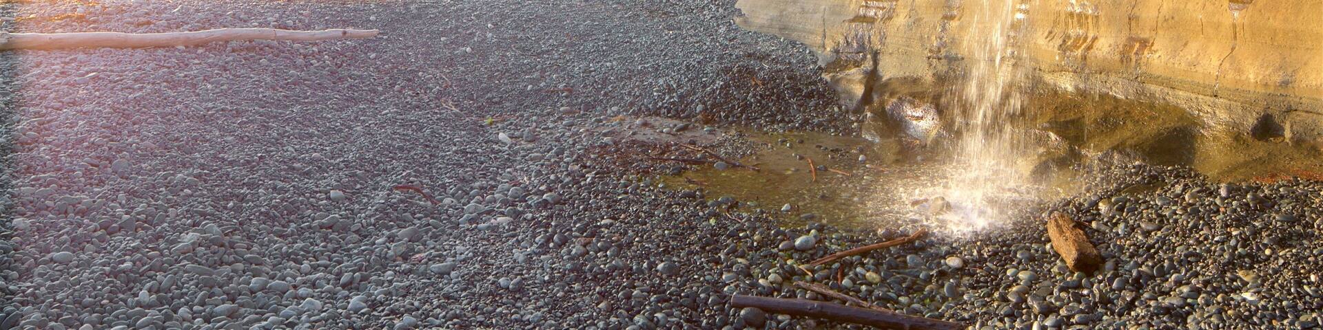 Sooke featuring a pebble beach and a sunset