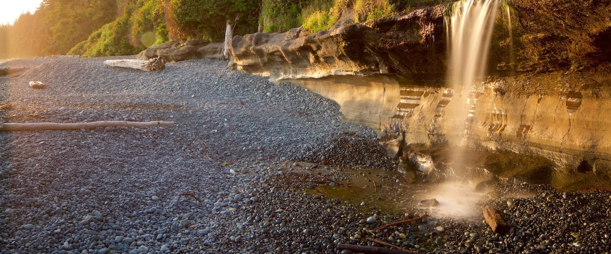 Sooke featuring a sunset and a pebble beach