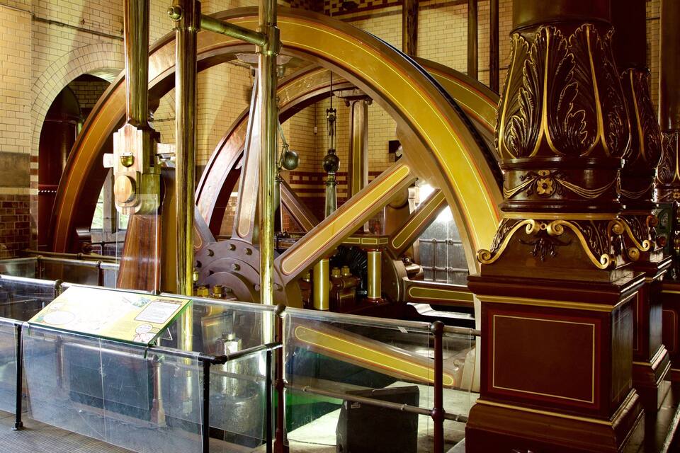 A historical building with large mechanical gears and ornate wooden structures.