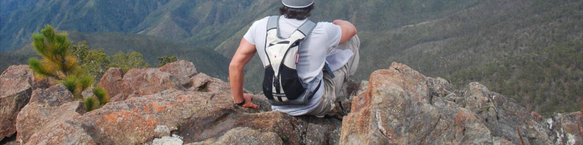 Pico Duarte featuring mountains and hiking or walking as well as an individual male