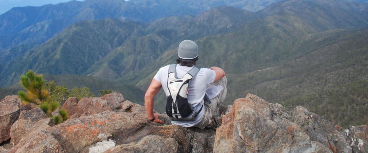 Pico Duarte featuring mountains and hiking or walking as well as an individual male