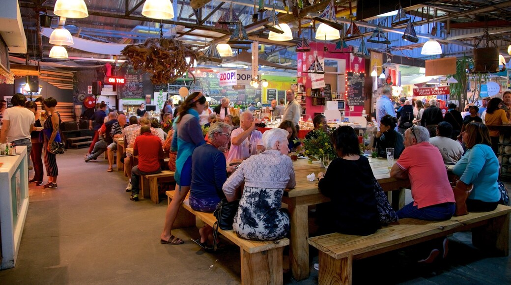 Hout Bay Craft Market featuring markets and interior views as well as a large group of people