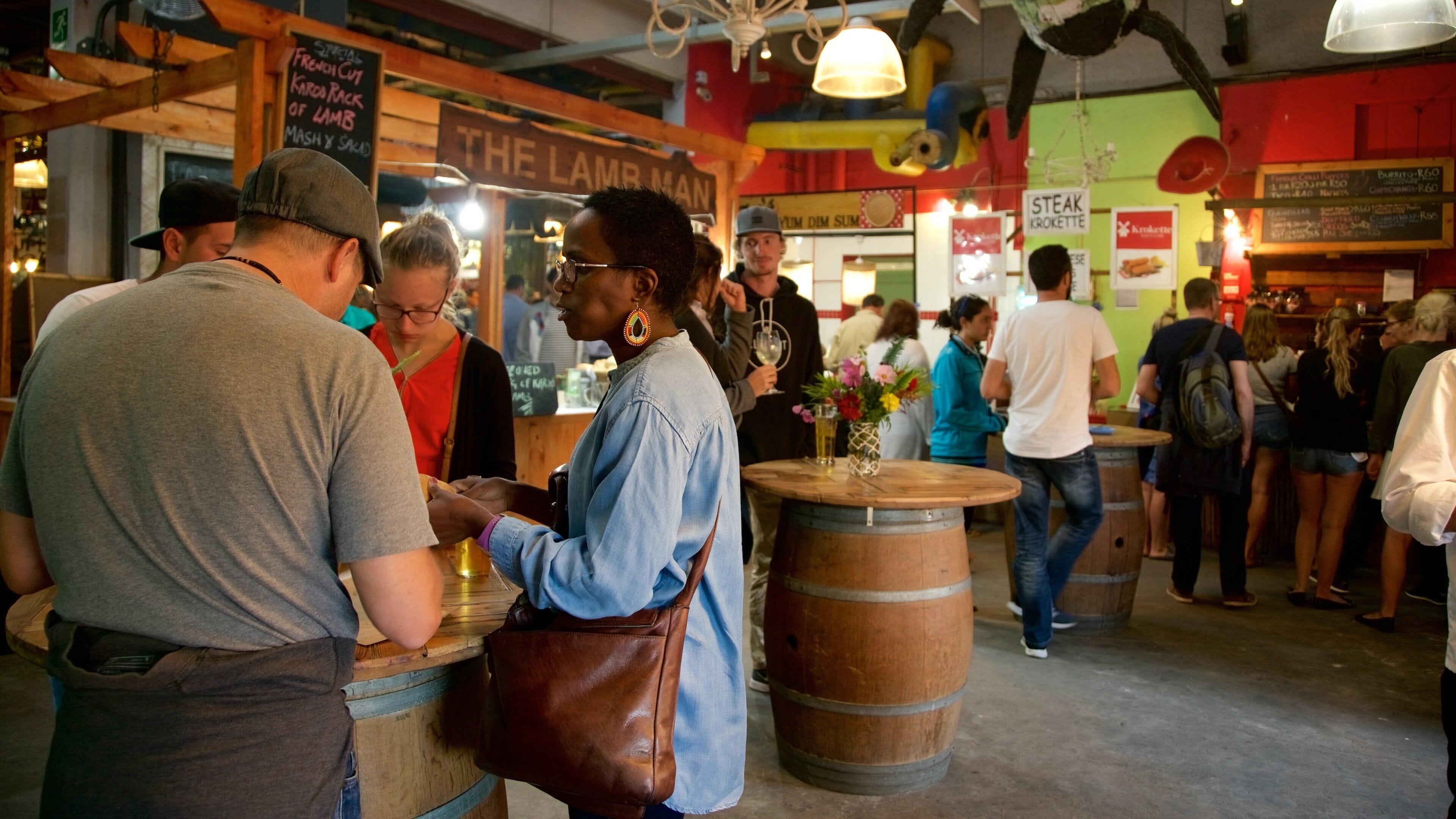 Bay Harbour Market showing interior views and markets as well as a large group of people