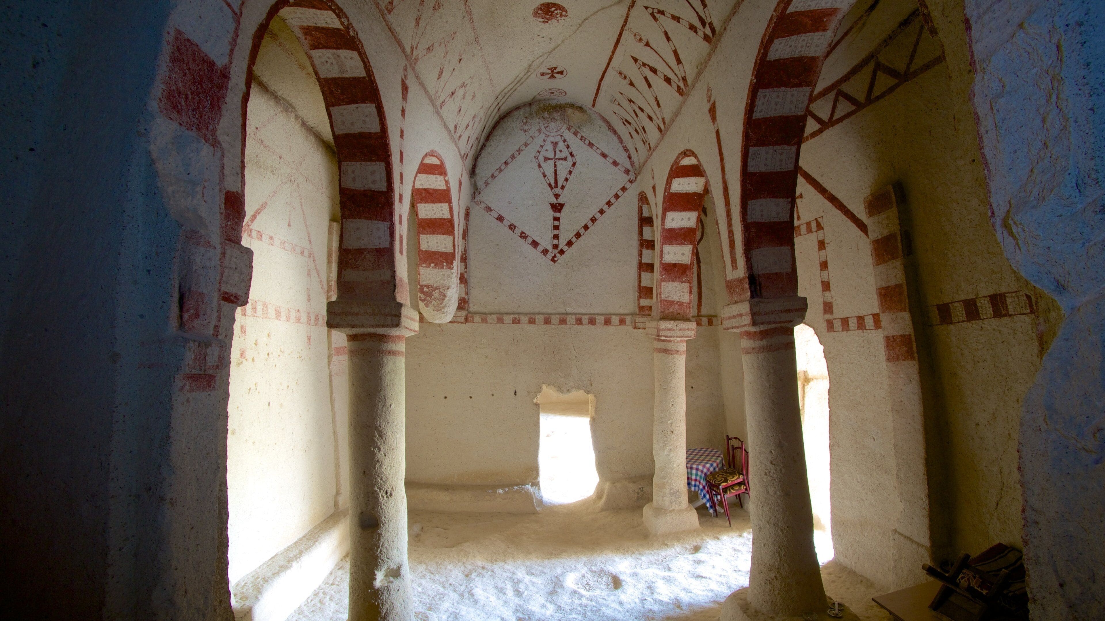 An interior with arches and geometric patterns.