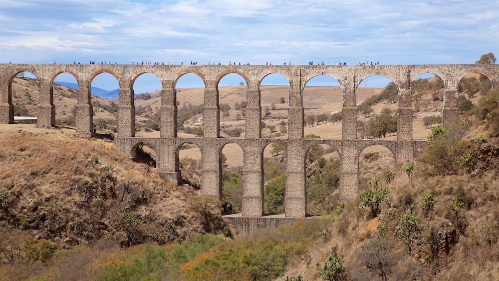 A stone viaduct with multiple arches spanning a valley.