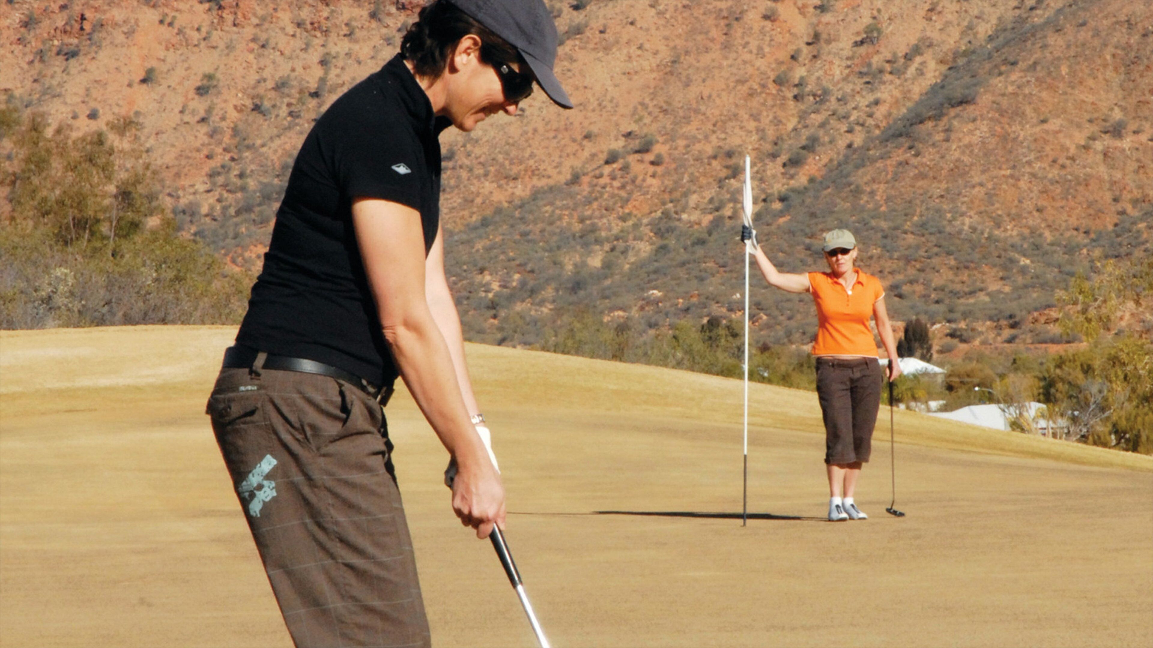 Alice Springs showing tranquil scenes and golf as well as a couple
