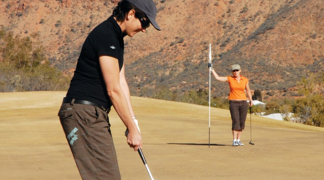 Alice Springs showing tranquil scenes and golf as well as a couple