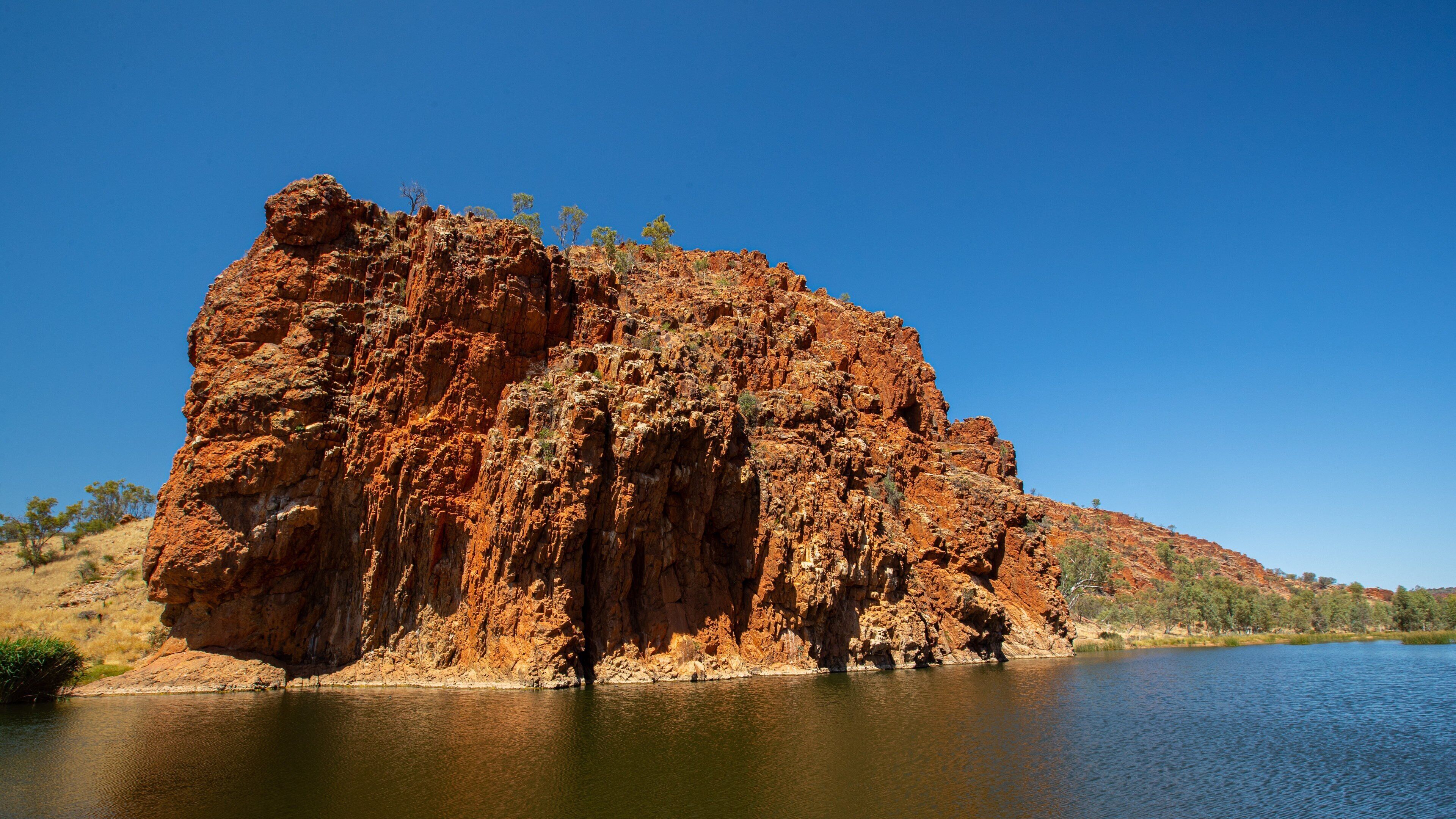 Glen Helen Gorge which includes a lake or waterhole and a gorge or canyon