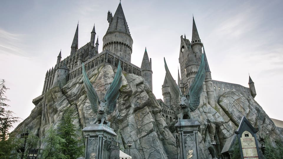 A large castle with multiple spires and a rocky facade.