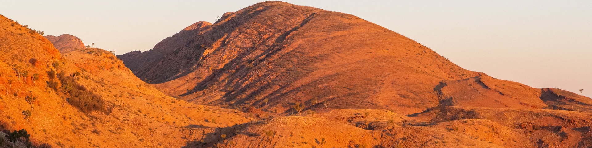 Ormiston Gorge featuring a sunset, desert views and mountains
