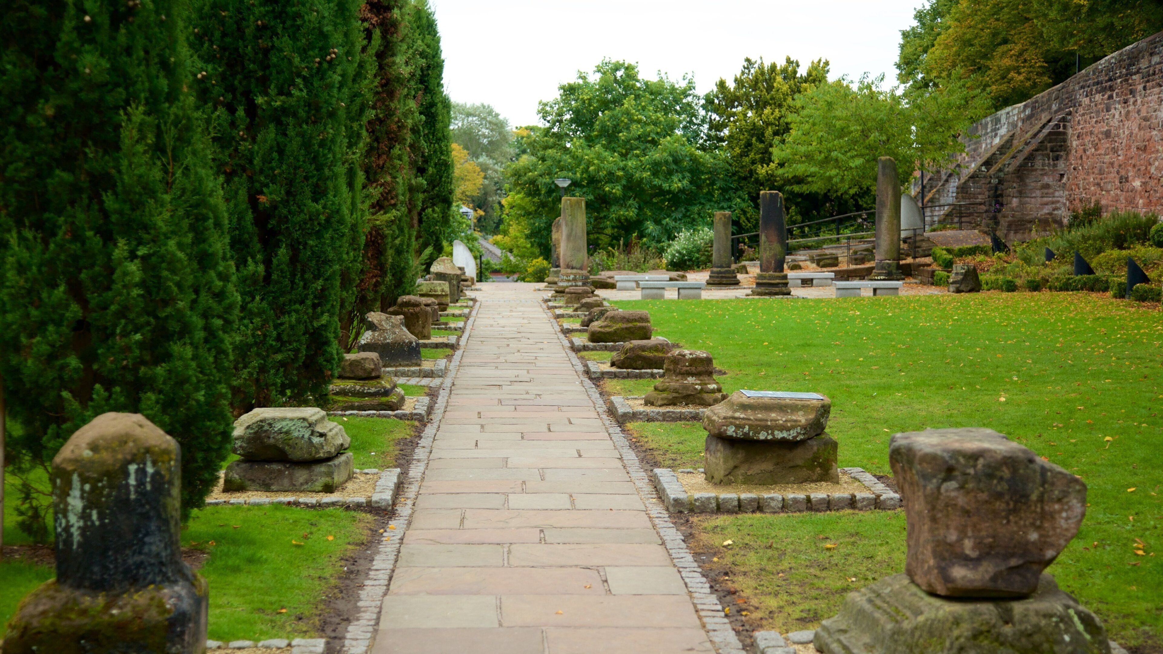 Chester Roman Gardens featuring a park, building ruins and heritage elements