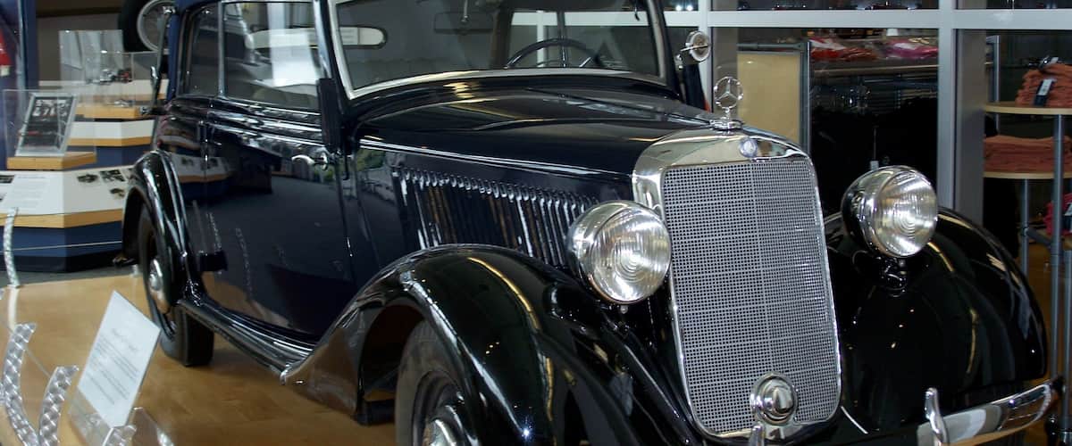A vintage black car with a classic design, chrome details, and a prominent front grille.