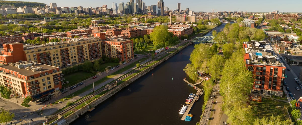 A river running through a city with modern buildings and a bridge.