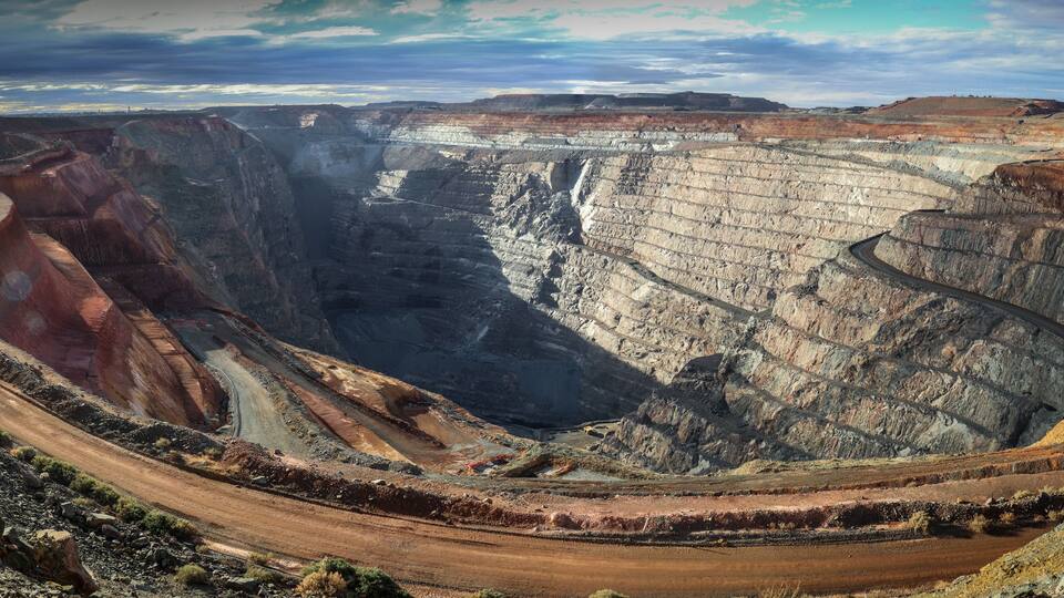 A panorama image of the Kalgoorlie gold mine Super Pit in the dusty late afternoon light.