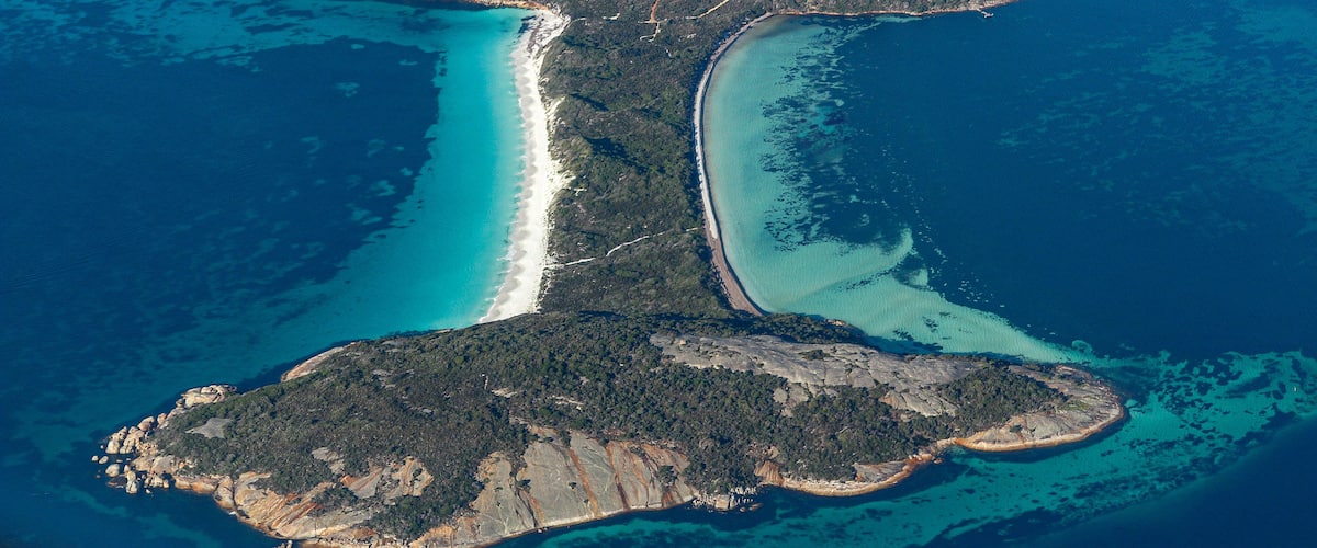 Areal view of Vancouver Peninsula, Albany WA. Beautiful land formation ending at the bottom and a thin stretch of a paradise beach with light and dark blue water. White sand beach, turquoise water.