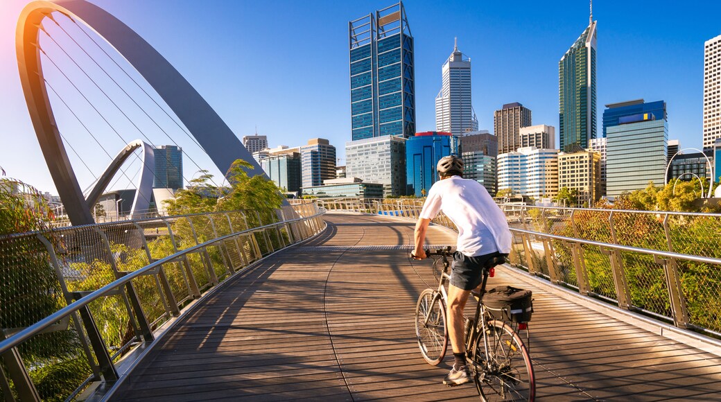 A man cycling on an elizabeth bridge in Perth city