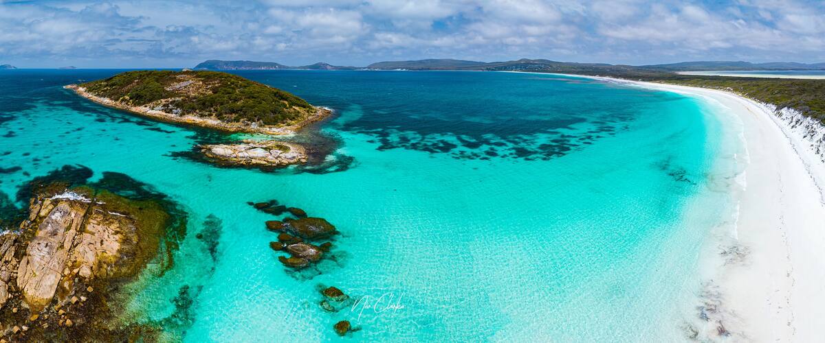 Aerial view of the turquoise waters and white sand of Goode Beach with rocky outcrops and coastal vegetation in Goode Beach, Western Australia, Australia.